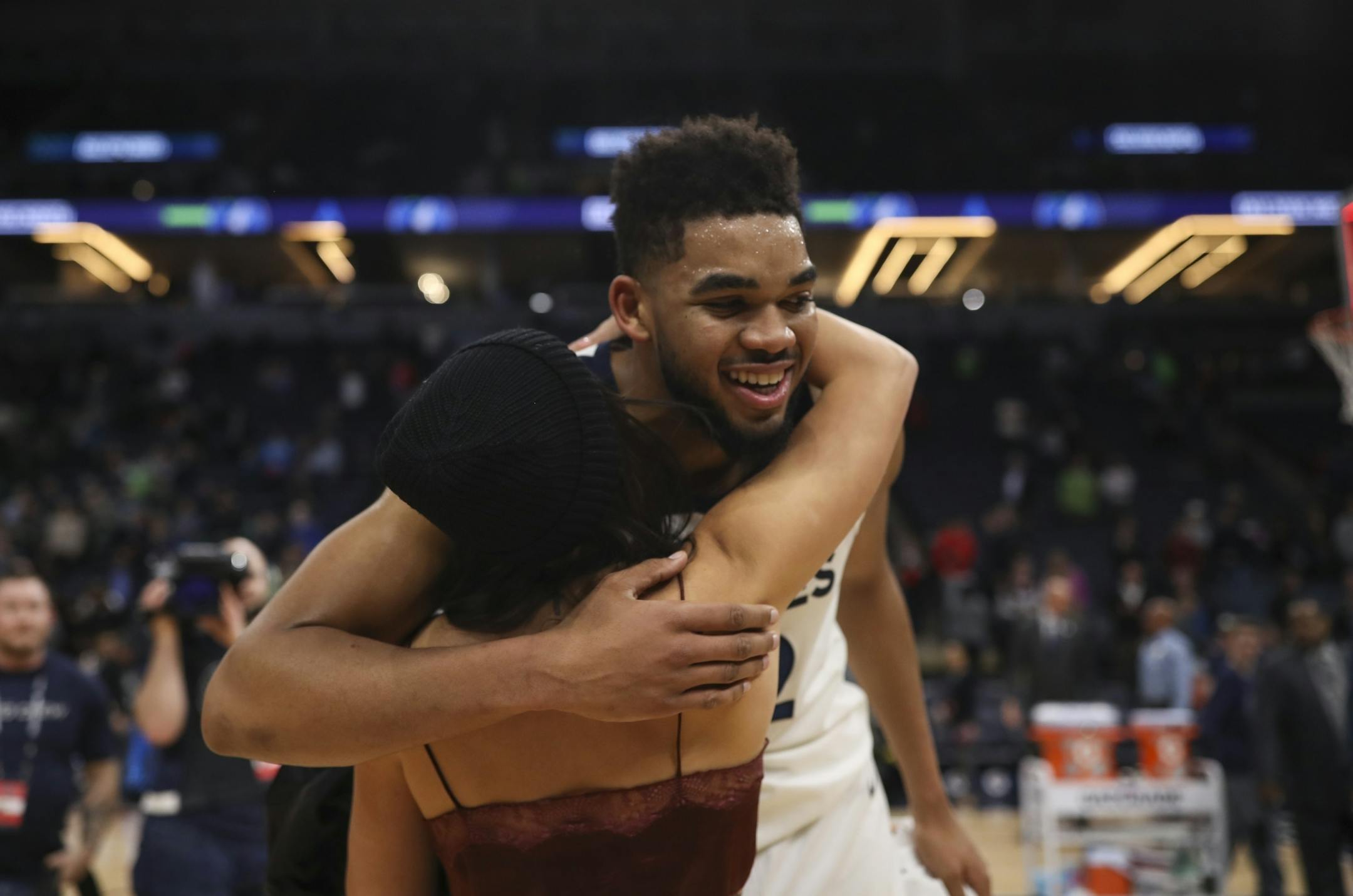 Minnesota Timberwolves center Karl-Anthony Towns (32) hugged his girlfriend on his way off the court after he set a franchise record with his 56 point effort over the Hawks.