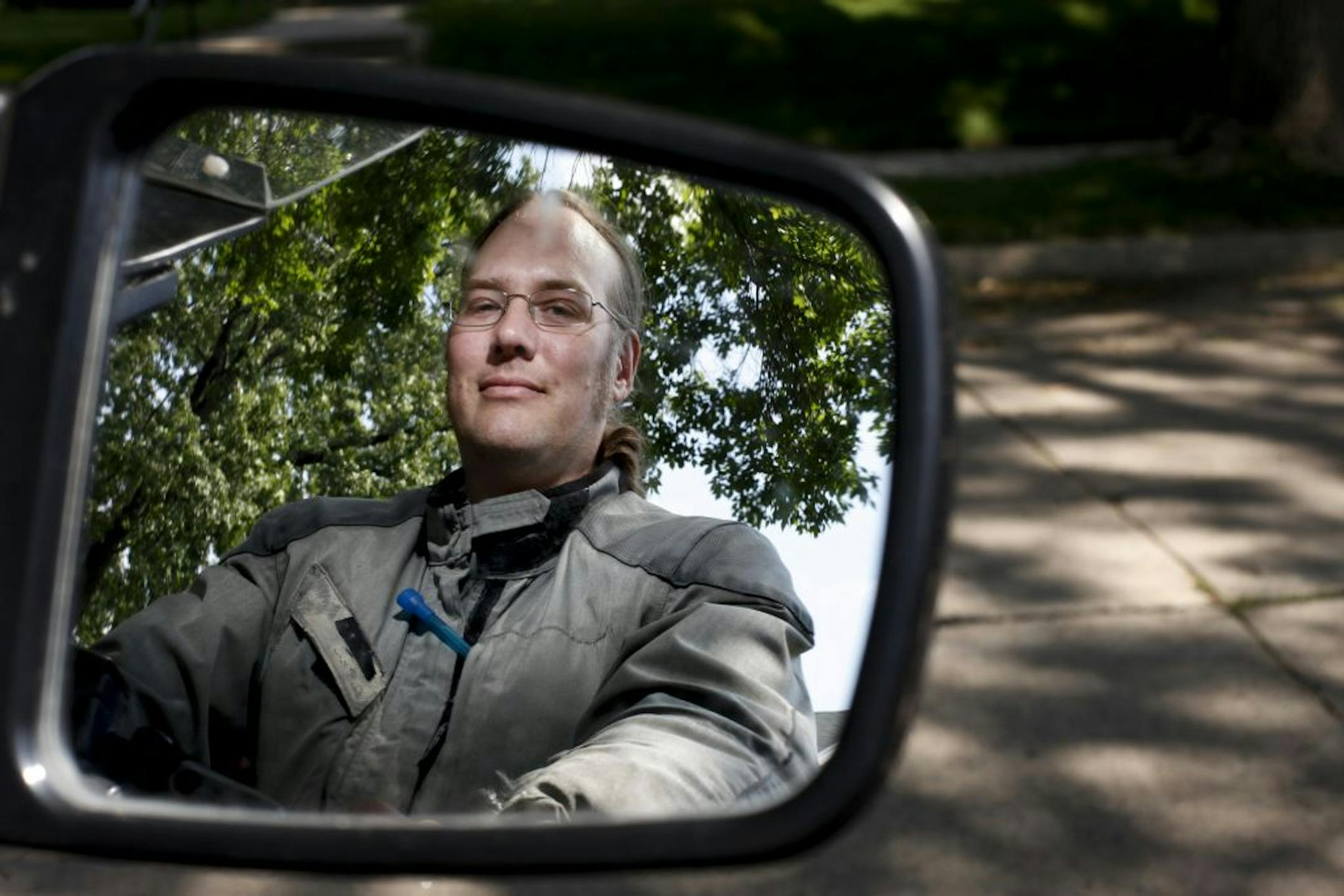Paul Ashman gazes into the mirror of one of motorcycles that has a recent patent invention called "Throttle Lock," a part specifically made for motorcycles that functions like cruise control on Thursday, June 7, 2012 in Minneapolis, Minn.