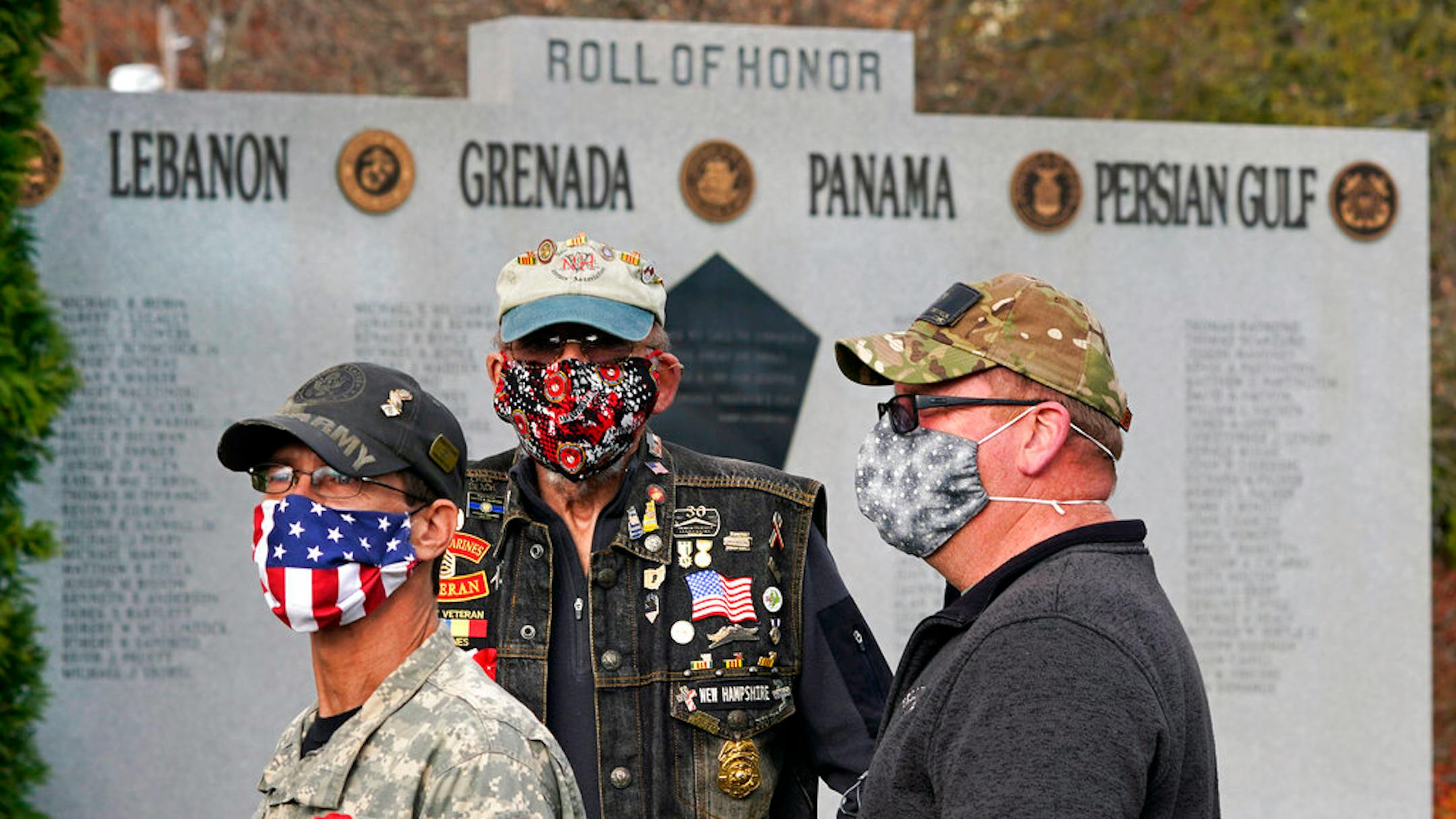 Veterans, wearing protective masks due to the COVID-19 virus outbreak, gather during a Veterans Day ceremony, Wednesday, Nov. 11, 2020, in Derry, N.H. (AP Photo/Charles Krupa)