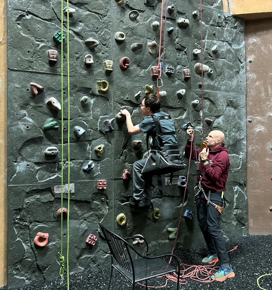 Highland Friendship Club member Joseph Nielsen tries out the climbing wall at Vertical Endeavors in St. Paul.