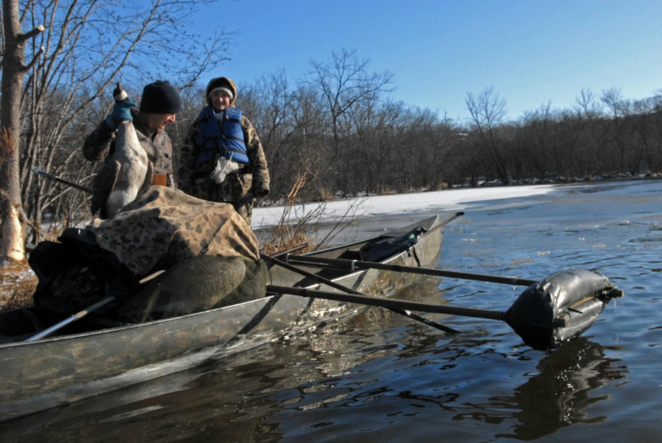 Wendell Diller loaded a goose shot by Dennis Anderson while Diller's wife, Galina, watched. The trio found more open water than usual at this time of the year.