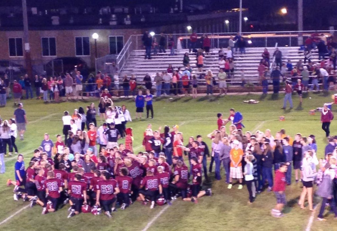 Moments after the Staples-Motley Cardinals broke a 39-game losing streak on Friday, fans stormed the football field to celebrate a 24-14 victory, last Friday, 8/21/15 its first win in five years. (Photo by Mike Schmidt - Special to the Star Tribune)