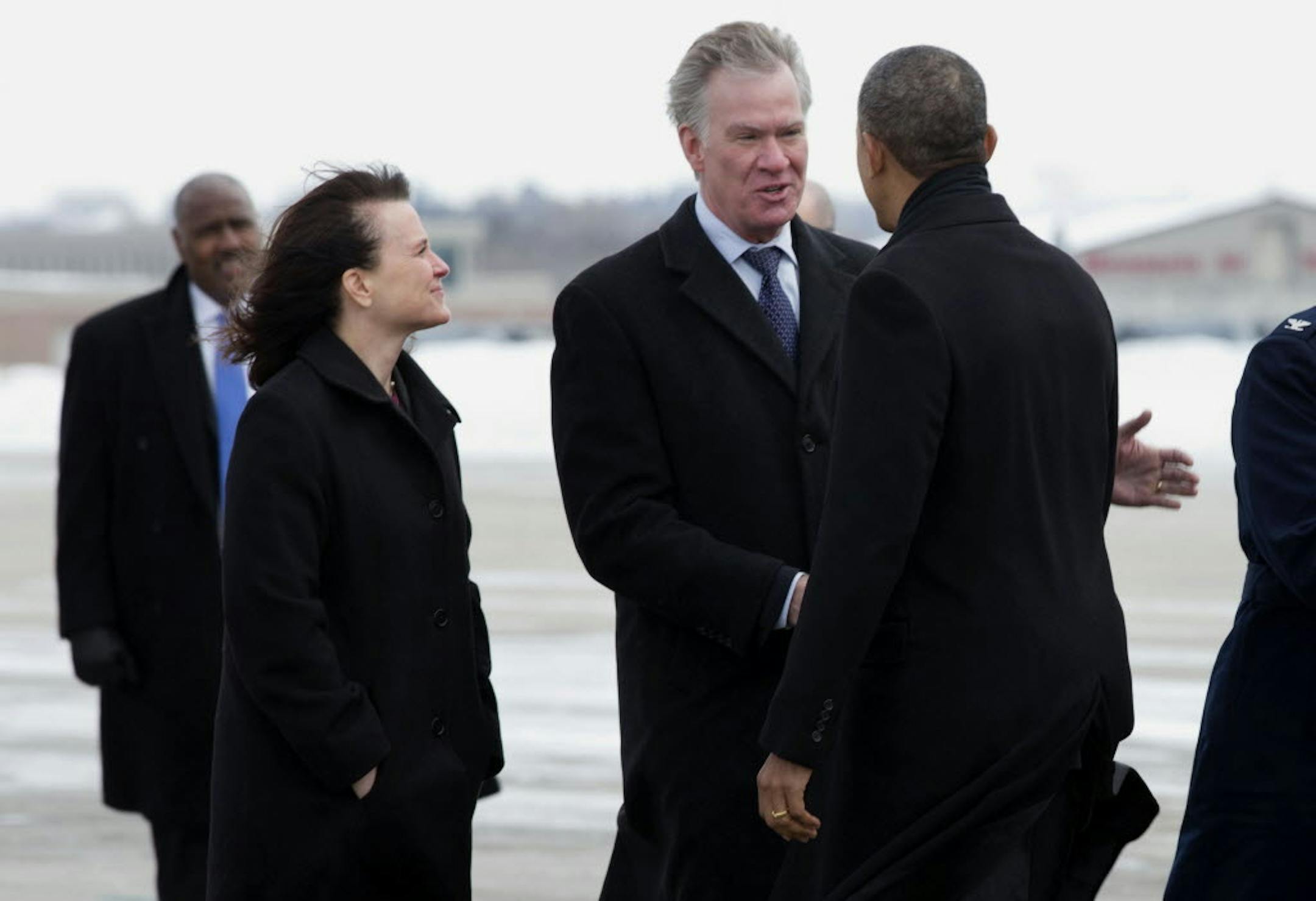 Feb. 26, 2014: St. Paul Mayor Chris Coleman greets President Barack Obama as he arrives at Minneapolis-St. Paul International Airport. Minneapolis Mayor Betsy Hodges is on the left.