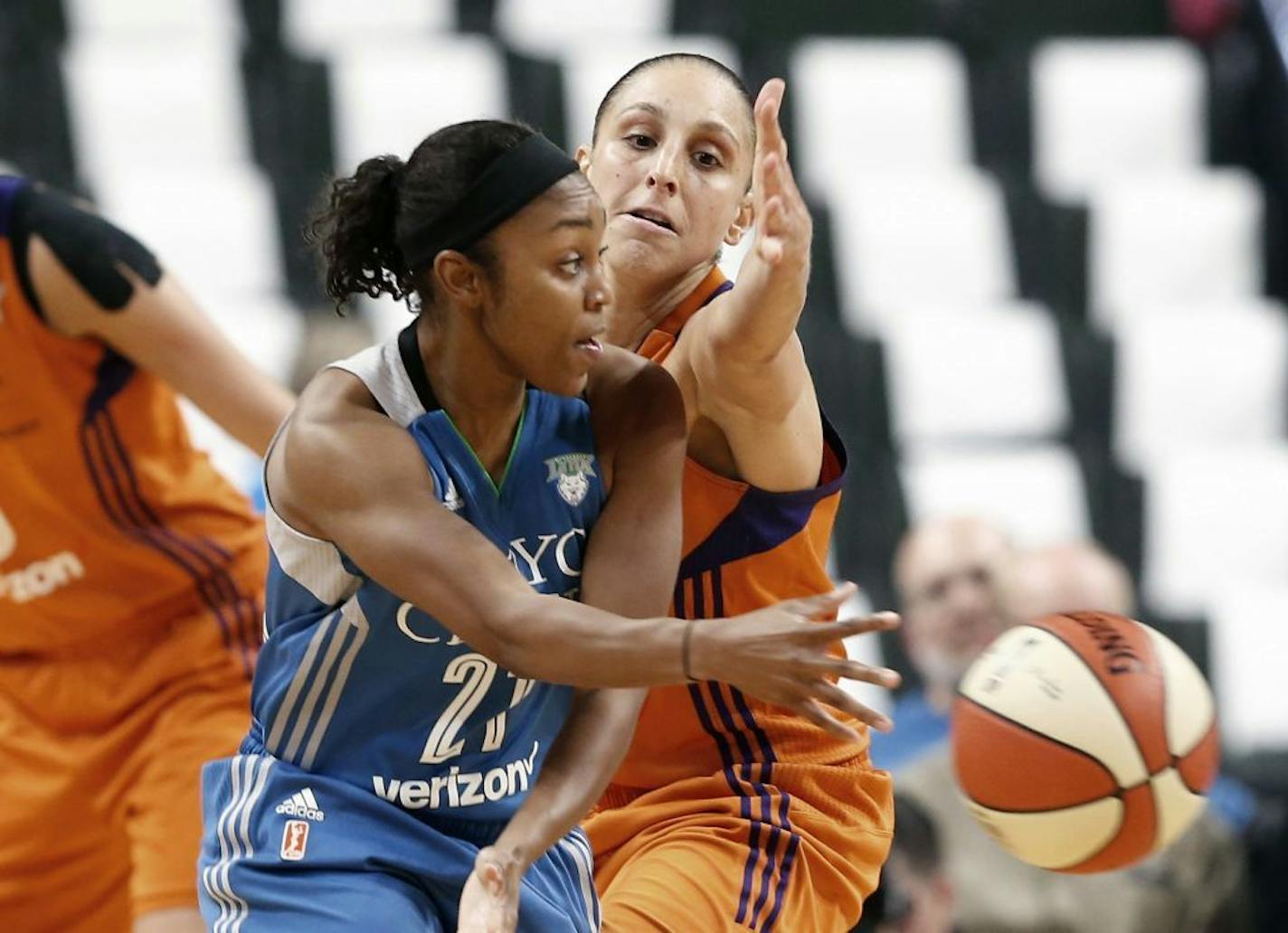 Minnesota Lynx's Renee Montgomery, left, passes the ball as Phoenix Mercury's Diana Taurasi defends in the second half of a WNBA playoff semi-finals basketball game Wednesday, Sept. 28, 2016, in St. Paul, Minn. The Lynx won 113-95. Taurasi led the Mercury with 25 points while Moore score 31 to lead the Lynx.