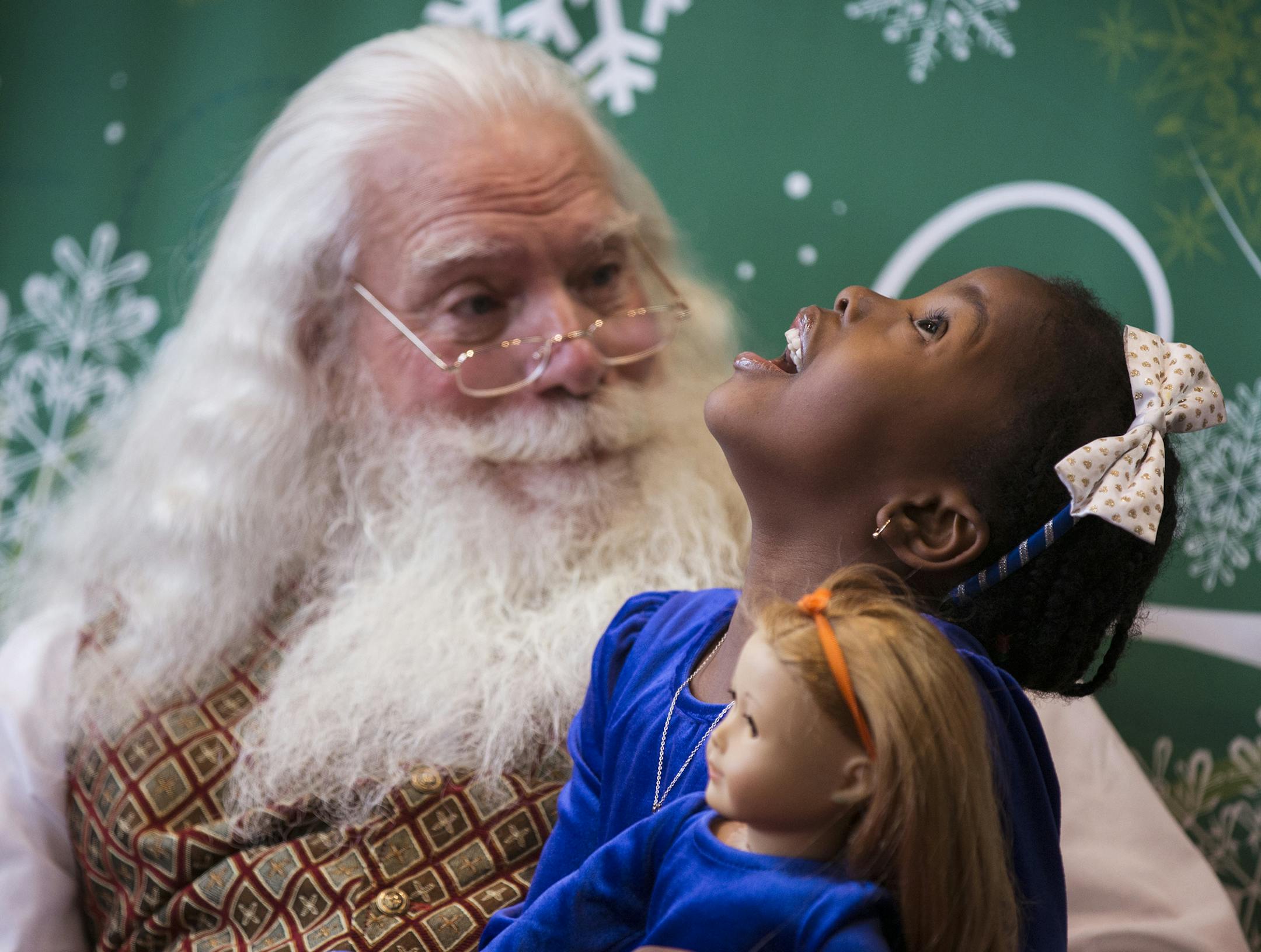Amanda Ojo, 5, of Bloomington talks with Santa (who would not give his real name) at Southdale Center in Edina on Thursday, December 24, 2015. ] (Leila Navidi/Star Tribune) leila.navidi@startribune.com