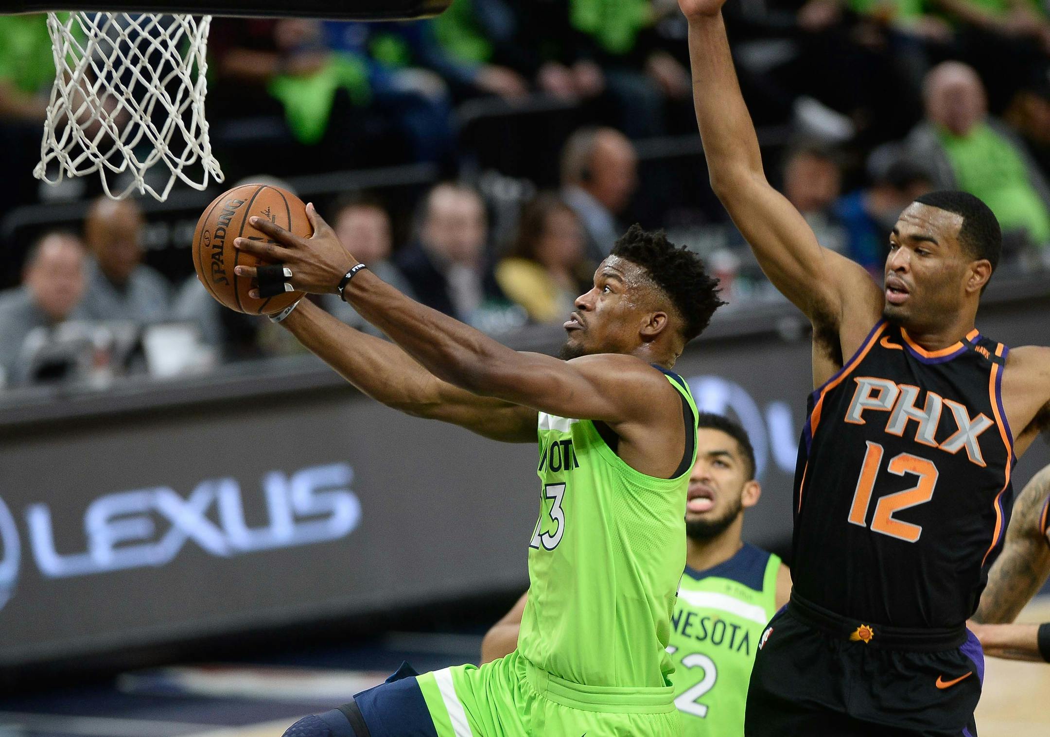 Minnesota Timberwolves guard Jimmy Butler (23) scored a layup in the first quarter with Phoenix Suns forward TJ Warren (12) in pursuit. ] AARON LAVINSKY ï aaron.lavinsky@startribune.com The Minnesota Timberwolves played the Phoenix Suns on Saturday, Dec. 16, 2017 at Target Center in Minneapolis, Minn.