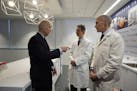 CORRECTS LAST NAME FROM LIVINE TO LEVINE- Vice President Joe Biden, left, gestures while speaking with Dr. Bruce L. Levine PH.D., center, and Dr. Carl