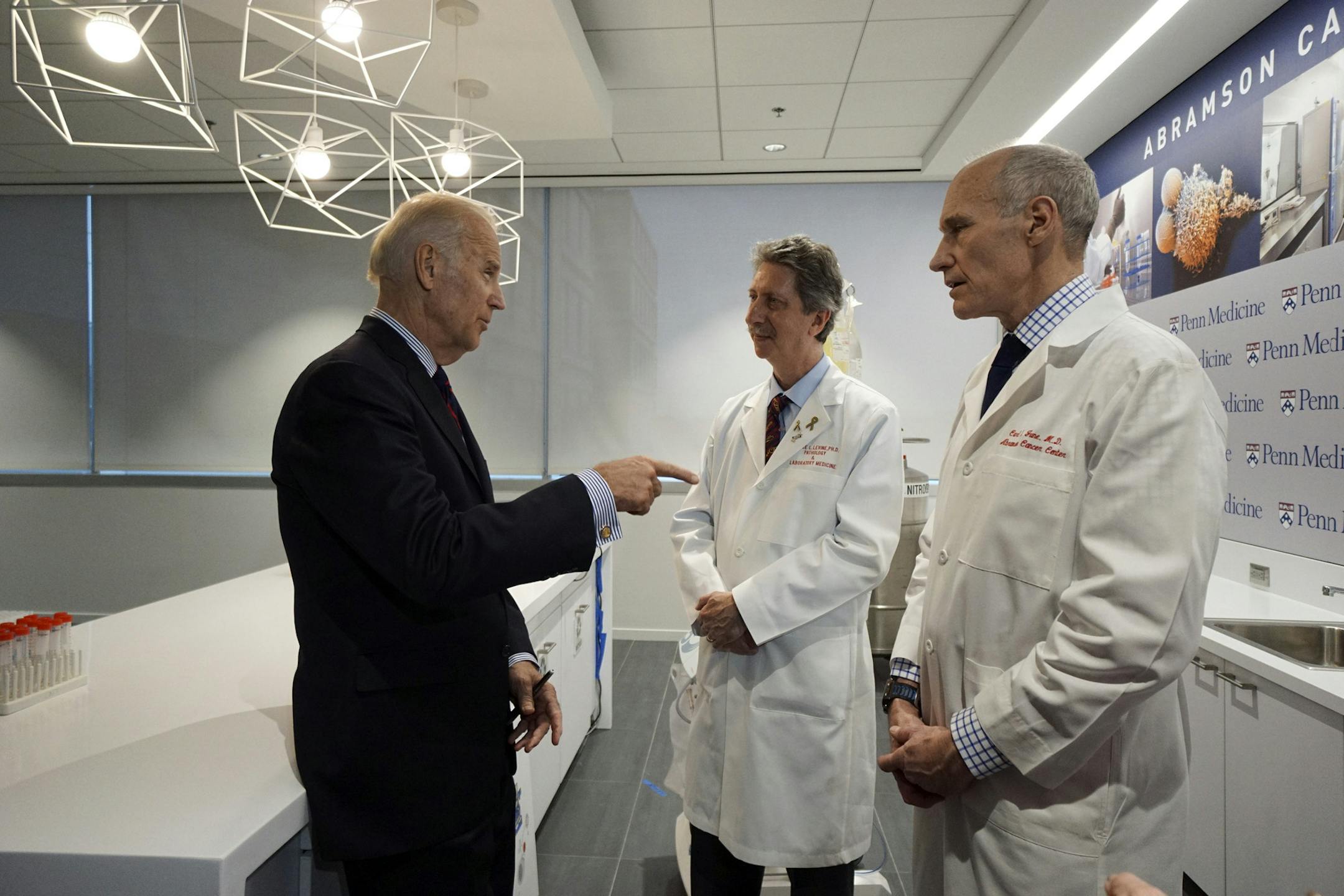CORRECTS LAST NAME FROM LIVINE TO LEVINE- Vice President Joe Biden, left, gestures while speaking with Dr. Bruce L. Levine PH.D., center, and Dr. Carl H. June M.D., Friday, Jan. 15, 2016, in the Abramson Cancer Center at the University of Pennsylvania in Philadelphia. (AP Photo/ Joseph Kaczmarek, Pool)
