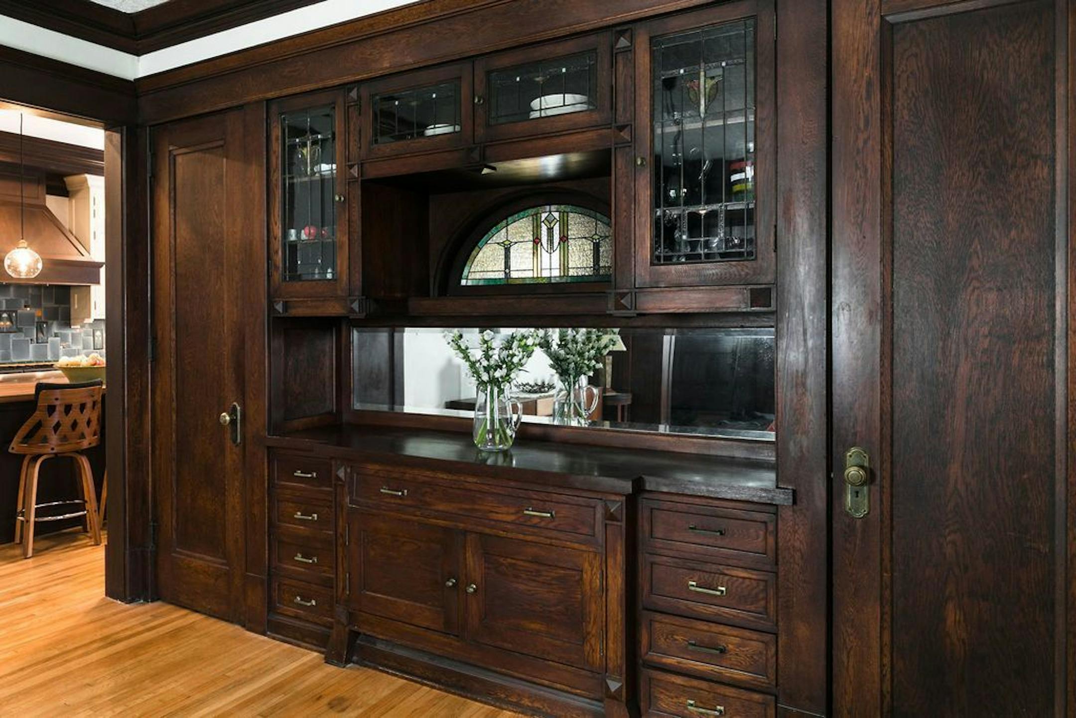 The owners of this St. Paul house fell in love with its original woodwork, including a built-in buffet with stained-glass window.