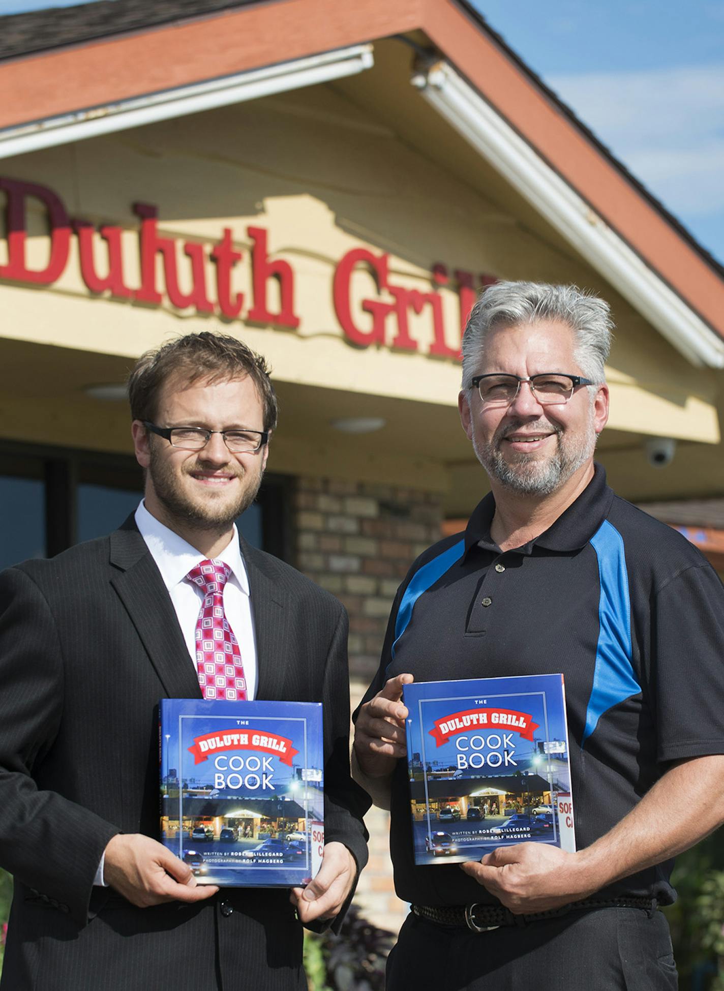 Tom Hanson and Robert Lillegard with the "Duluth Grill Cookbook."