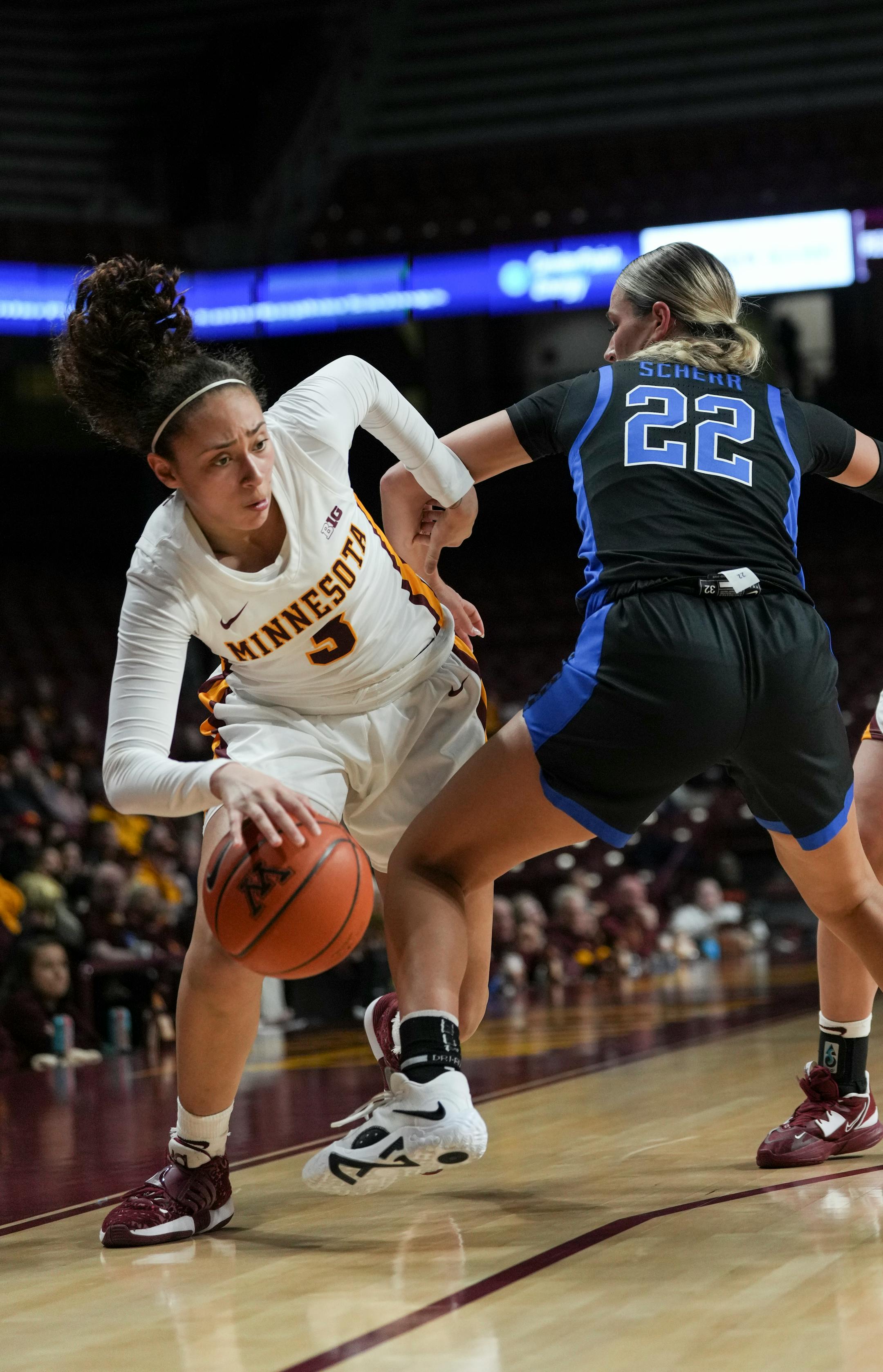 Minnesota Gophers guard Amaya Battle (3) gets tangled with Kentucky Wildcats guard Maddie Scherr (22) in the first half. A foul was called on Kentucky Wildcats guard Maddie Scherr (22).