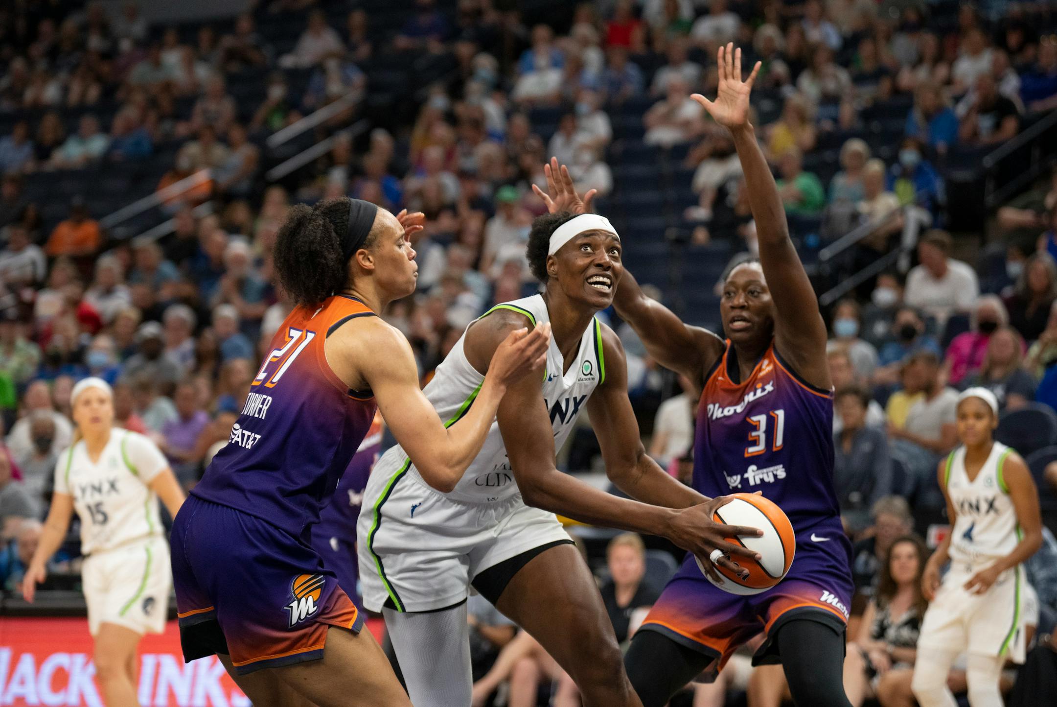 In her first game back after an injury, Minnesota Lynx center Sylvia Fowles (34) split the defense of Phoenix Mercury forward Brianna Turner (21) and Mercury center Tina Charles (31) while on a second quarter drive to the net.