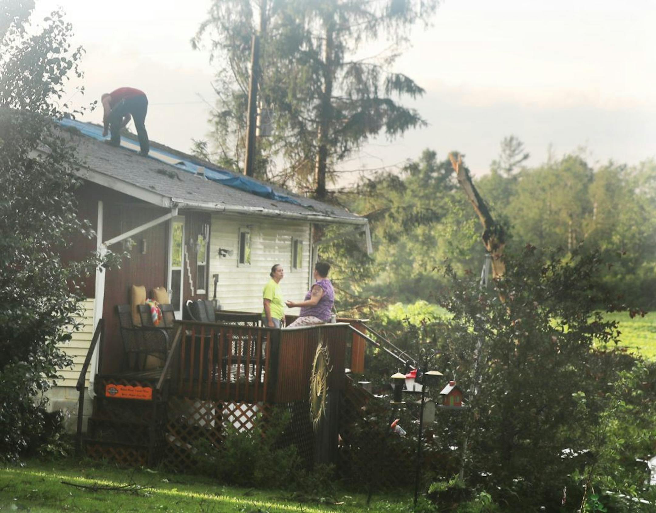 Damage to a home and trees after a strong afternoon thunderstorm moved through Friday, July 19, 2019, in Barron, WI.