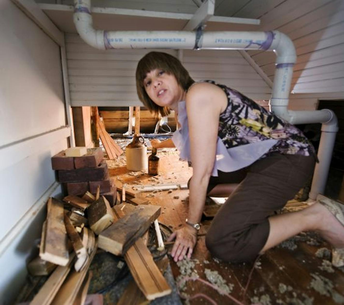 Mary Shanesy in the area where the alcohol was found. Folks at the Hennepin History Museum are trying to figure out who might have once owned the stash. Besides the booze, there was some wine whose time had long since come and gone.