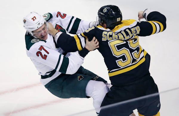 Boston Bruins center Noel Acciari (55) lines up a punch in his fight against Minnesota Wild center Zac Dalpe (27) during the first period of an NHL ho