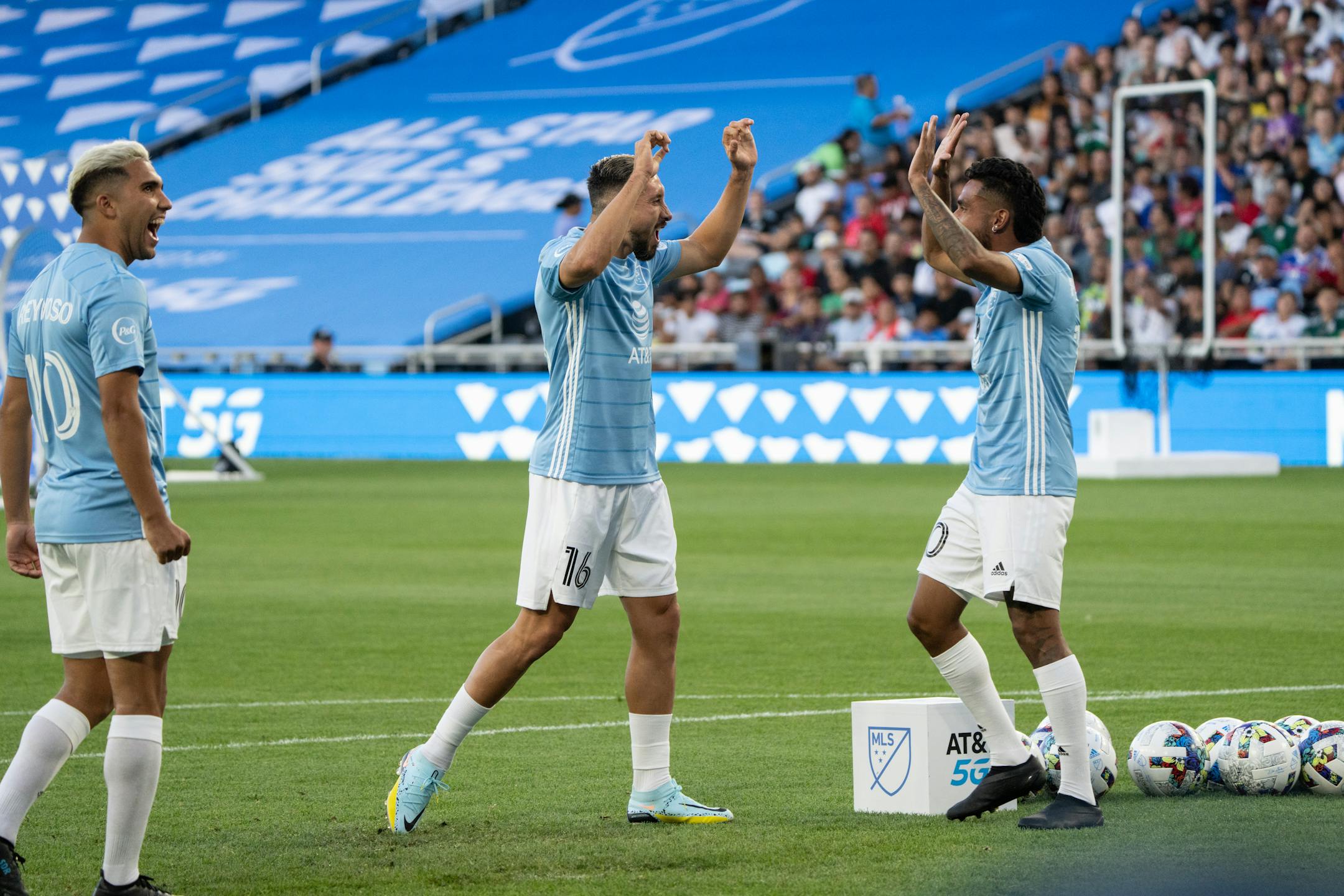Minnesota United FC midfielder Emanuel Reynoso, Houston Dynamo FC midfielder Hector Herrera and FC Dallas forward Jes's Ferreira  celebrate winning the shooting challenge 136-74 against Liga MX.