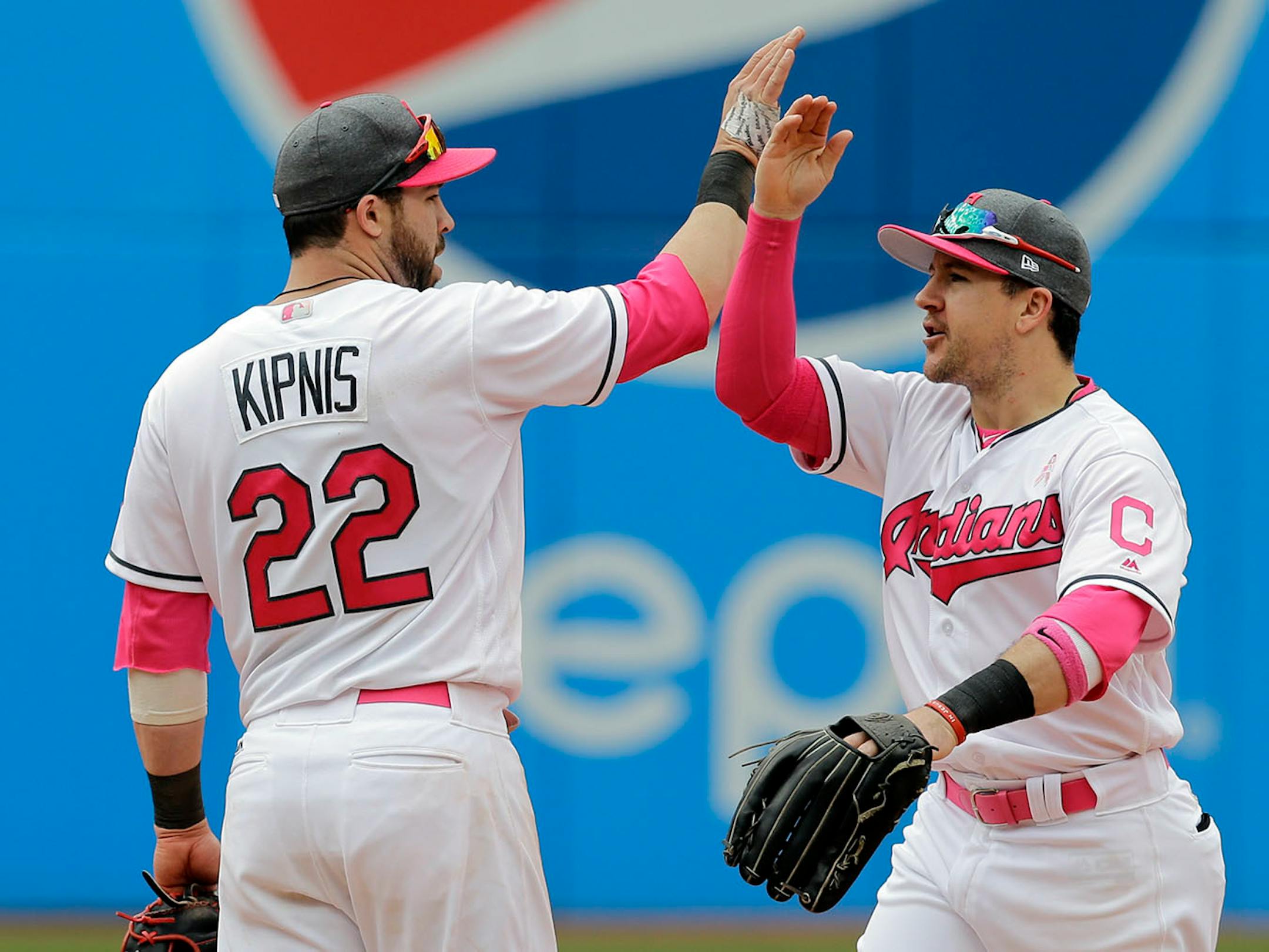 Cleveland Indians' Jason Kipnis, left, is congratulated by teammate Daniel Robertson after the Indians defeated the Minnesota Twins 8-3 in a baseball game, Sunday, May 14, 2017, in Cleveland.