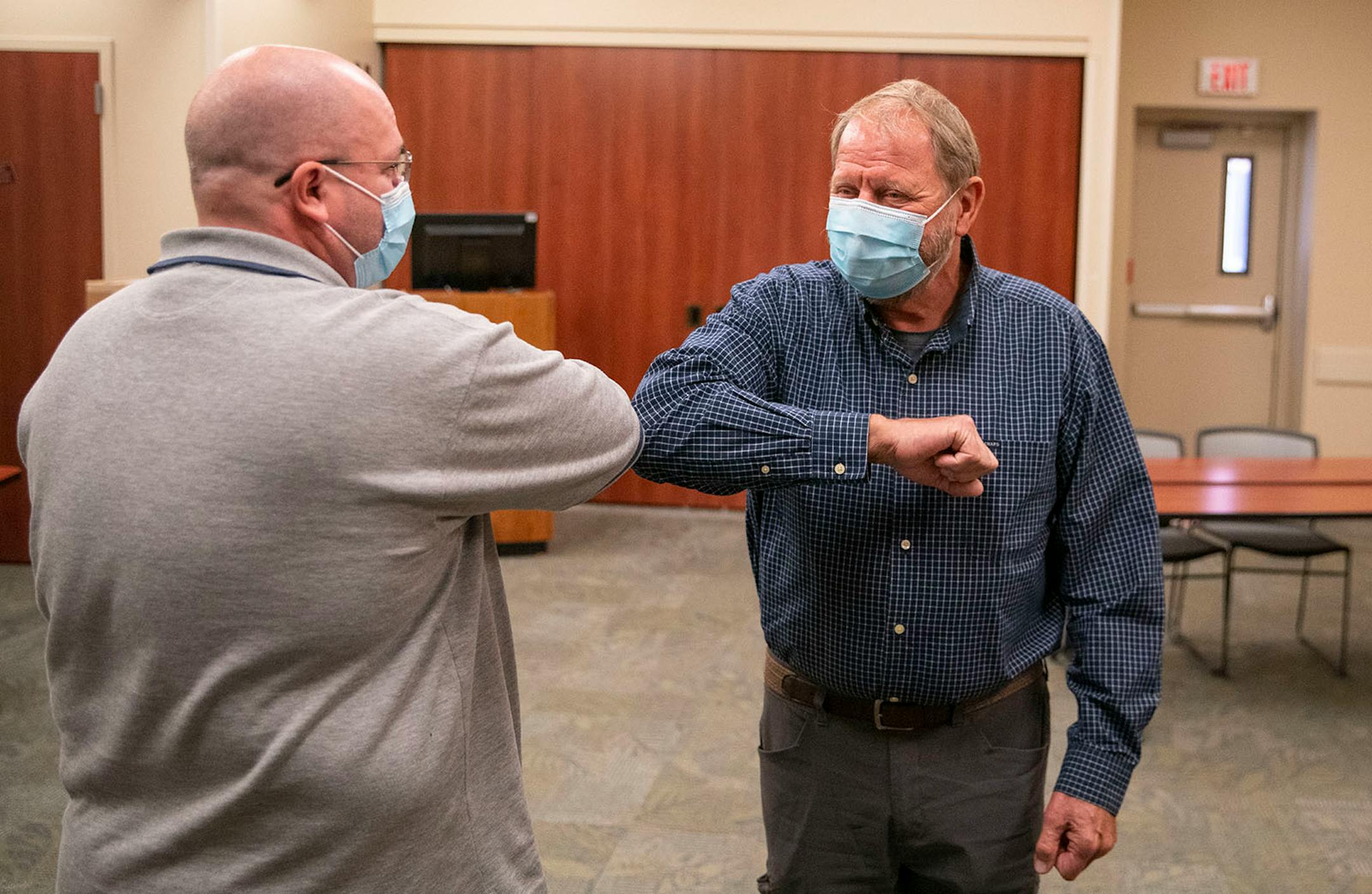 (Left) Tim White and Bob Schlicht exchanged an elbow bump to start their meeting at Essentia Health-St. Mary's Medical Center in Duluth on Friday October 16, 2020. The two men are the only people in the world to have received the experimental treatment that saved both their lives.
