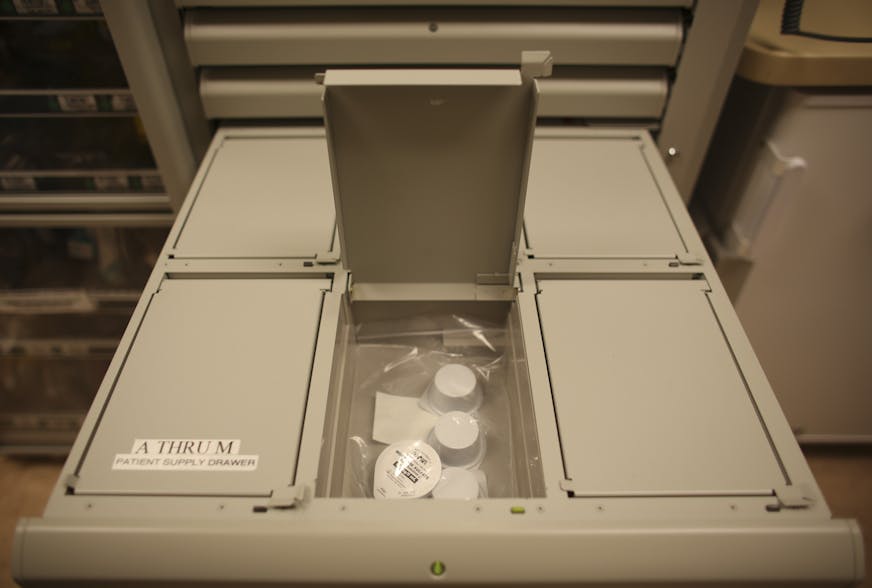 The computer controlled machine that dispenses narcotics and other drugs on the burn unit floor at Hennepin County Medical Center Wednesday, October 23, 2013. After patient information is input by a nurse, a drawer opens up. Drawers that contain narcotics have compartments with covers that don't reveal their contents. A patient's supply of morphine can be seen in the open compartment of this drawer. ] JEFF WHEELER &#x201a;&#xc4;&#xa2; jeff.wheeler@startribune.com