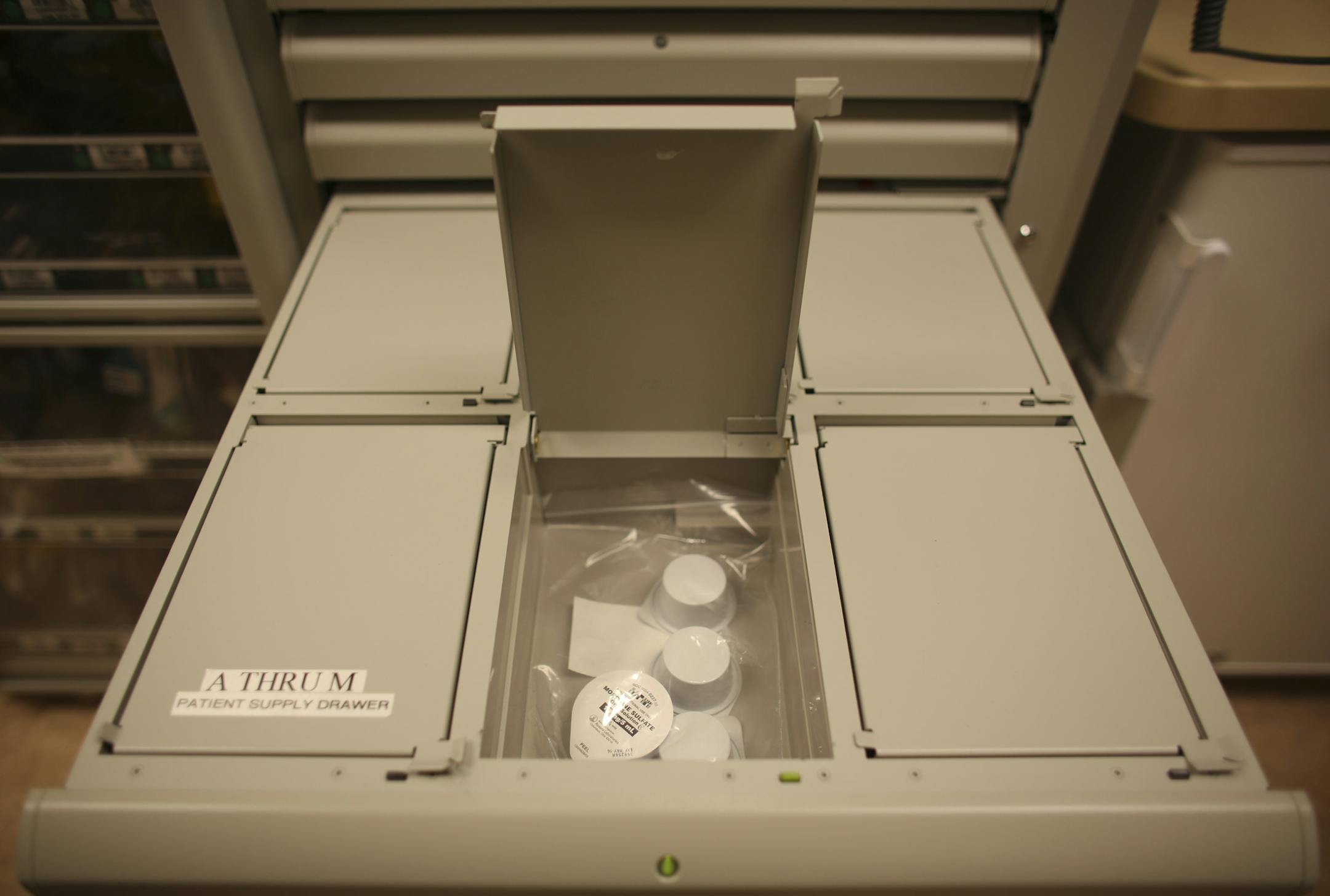The computer controlled machine that dispenses narcotics and other drugs on the burn unit floor at Hennepin County Medical Center Wednesday, October 23, 2013. After patient information is input by a nurse, a drawer opens up. Drawers that contain narcotics have compartments with covers that don't reveal their contents. A patient's supply of morphine can be seen in the open compartment of this drawer. ] JEFF WHEELER &#x201a;&#xc4;&#xa2; jeff.wheeler@startribune.com