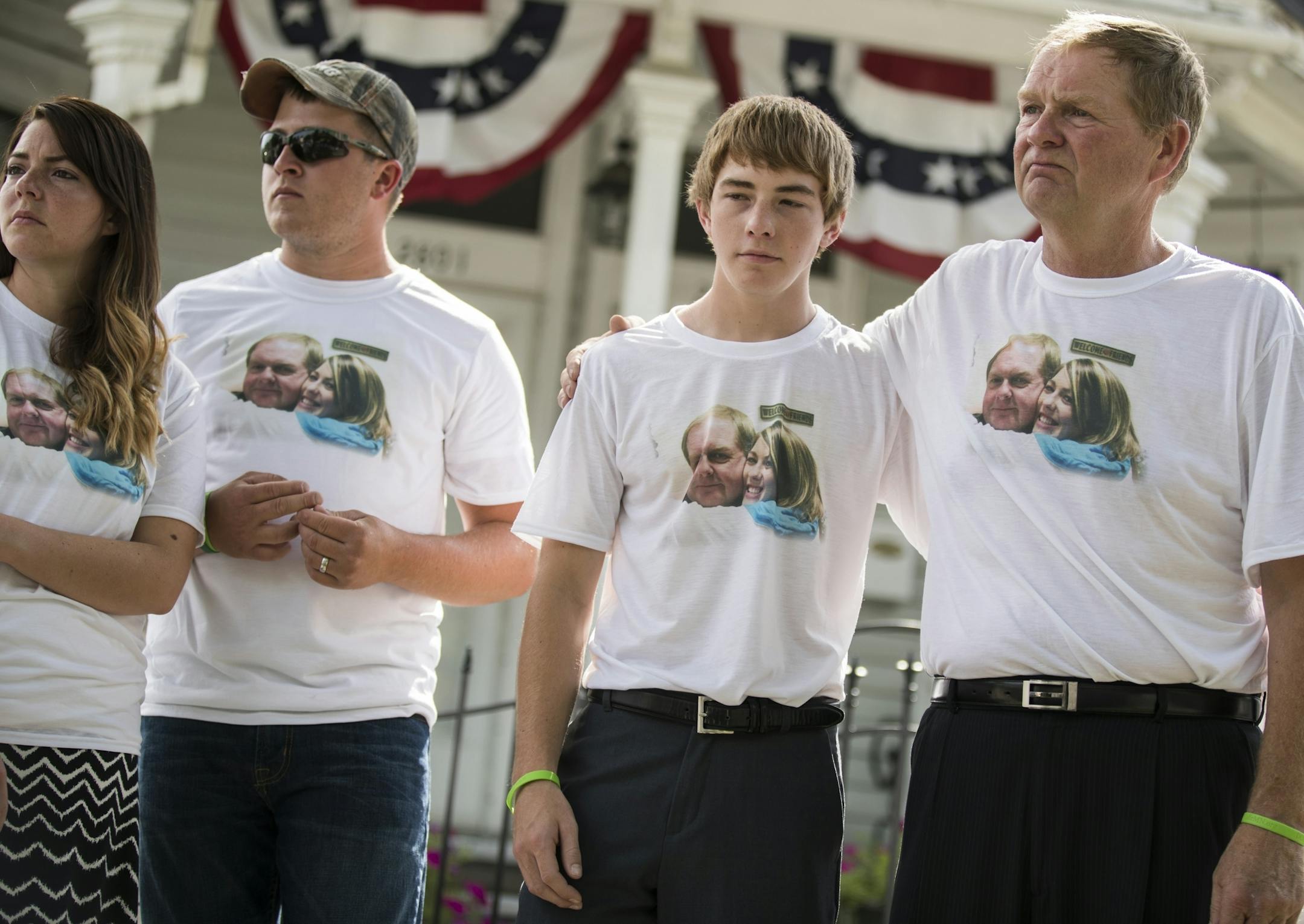Jerome Hanson, from right, with his son Hunter Hanson, 15, son-in-law Travis Weigand and daughter Amanda Weigand, stands during a memorial for his other daughter Jessica Hanson in Minneapolis.