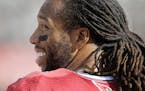 Arizona Cardinals wide receiver Larry Fitzgerald smiles on the sideline during the first half of an NFL preseason football game against the Oakland Ra