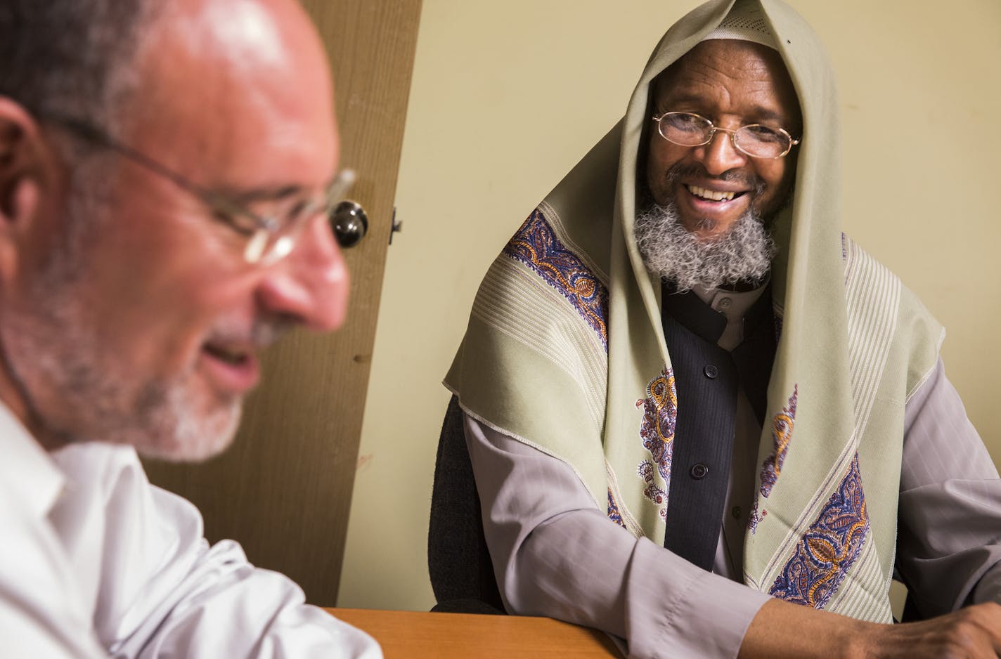 Imam Ahmed Burale and U.S. Attorney Andrew Luger talked during a meeting of the Somali American Task Force. The task force was created to encourage local voices to help develop tactics to eradicate roots of extremism.