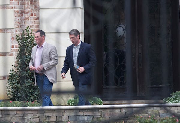 Minnesota Vikings head coach Mike Zimmer, left, and general manager Rick Spielman left Adrian Peterson's home in Texas after a meeting in March.