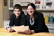In this Jan. 4, 2013, photo, Janell Burley Hofmann, right, poses with her son Gregory at their home in Sandwich, Mass. Janell holds a copy of the cont