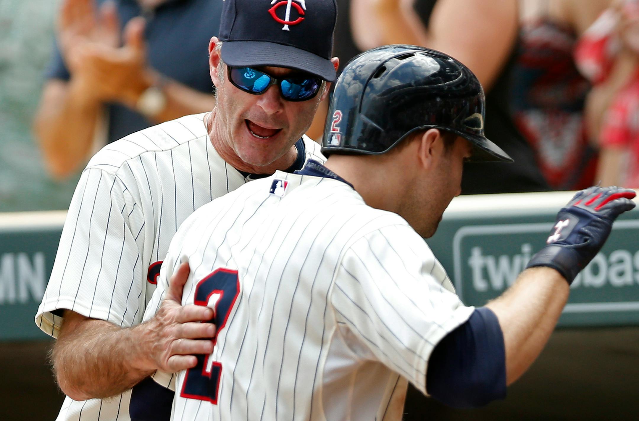 Manager Paul Molitor, left, and second baseman Brian Dozier found different ways to suggest the 2016 edition of the Twins has the talent and mental toughness to make the playoffs this season.