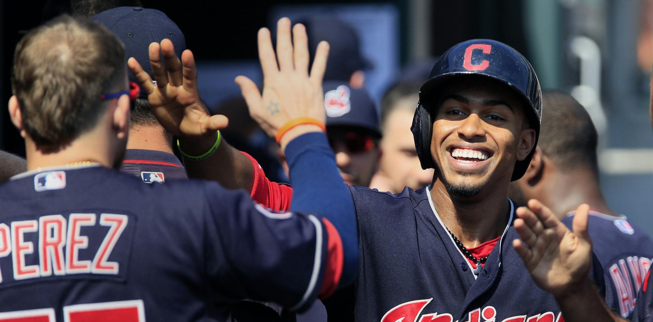 Cleveland Indians' Francisco Lindor, right, is congratulated by Roberto Perez (55) after scoring against the Detroit Tigers during the sixth inning of a baseball game Sunday, Sept. 6, 2015, in Detroit. (AP Photo/Duane Burleson) ORG XMIT: MIN2015091115464277