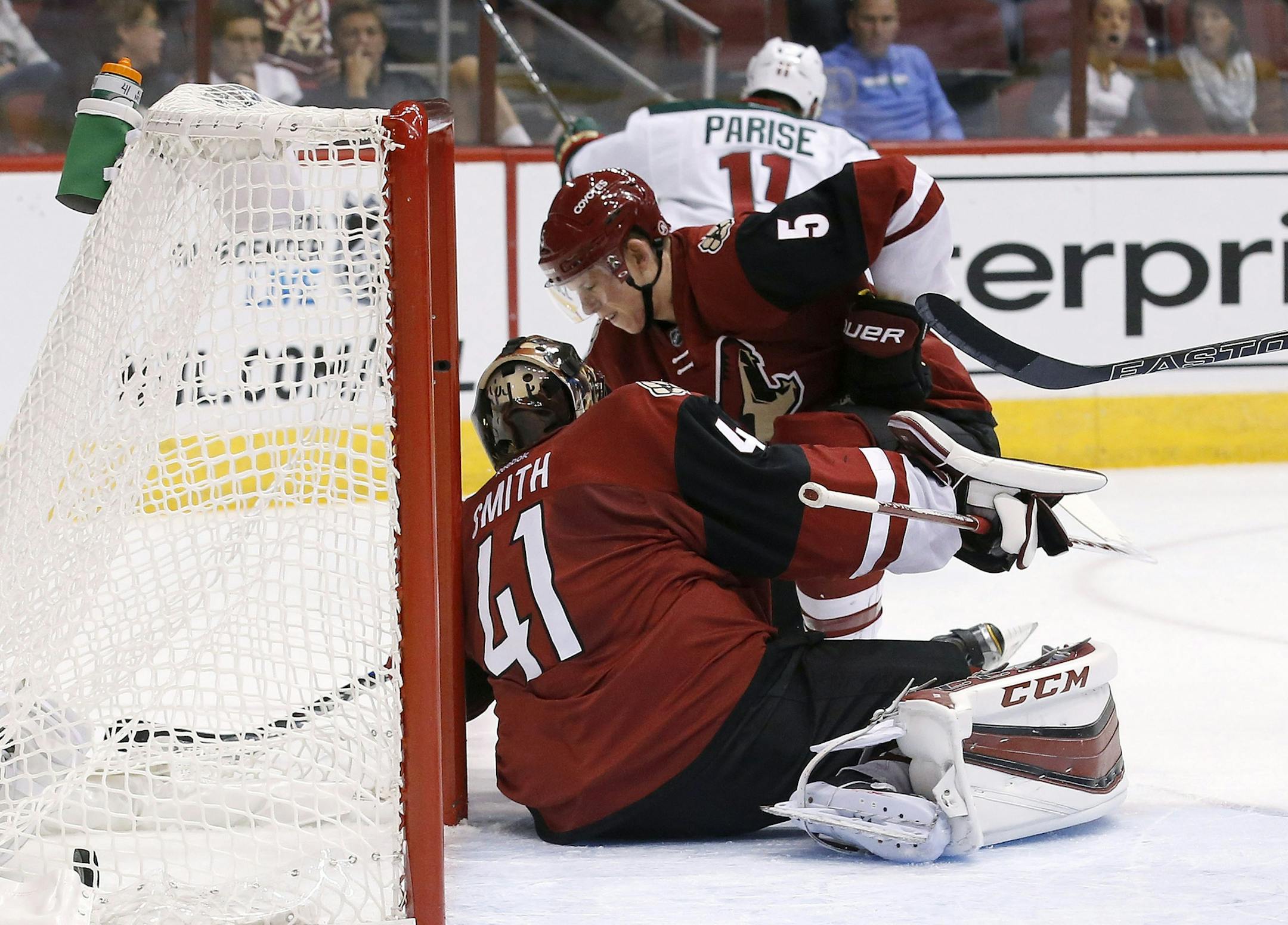 Minnesota Wild's Zach Parise (11) skates away to celebrate after scoring a goal against Arizona Coyotes' Mike Smith (41) as Coyotes' Connor Murphy (5) is unable to help defend during the first period of an NHL hockey game Thursday, Oct. 15, 2015, in Glendale, Ariz. (AP Photo/Ross D. Franklin)