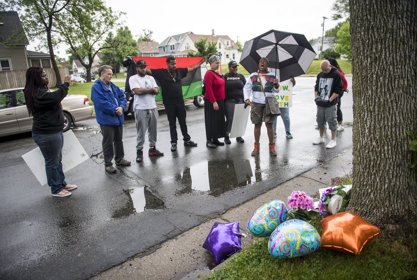 Pastor Carmen Means, carrying umbrella, led community members in prayer at the site of a memorial for Birdell Beeks, the 59-year-old woman killed in a shooting Thursday night. Means is a pastor for The Movement Church and is an organizer with Black Clergy United for Change. ] (AARON LAVINSKY/STAR TRIBUNE) aaron.lavinsky@startribune.com Next day followup on the fatal shooting of Birdell Beatrice Beeks, a 59-year-old woman killed in a fatal shooting Thursday night.