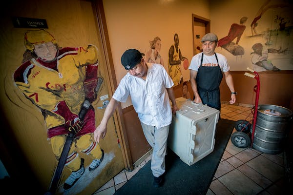 Tony's Diner owner, Tony Nicklow, right, and Pedro Juma carried crates of breakfast to his delivery van to feed the entire Gophers football team.
