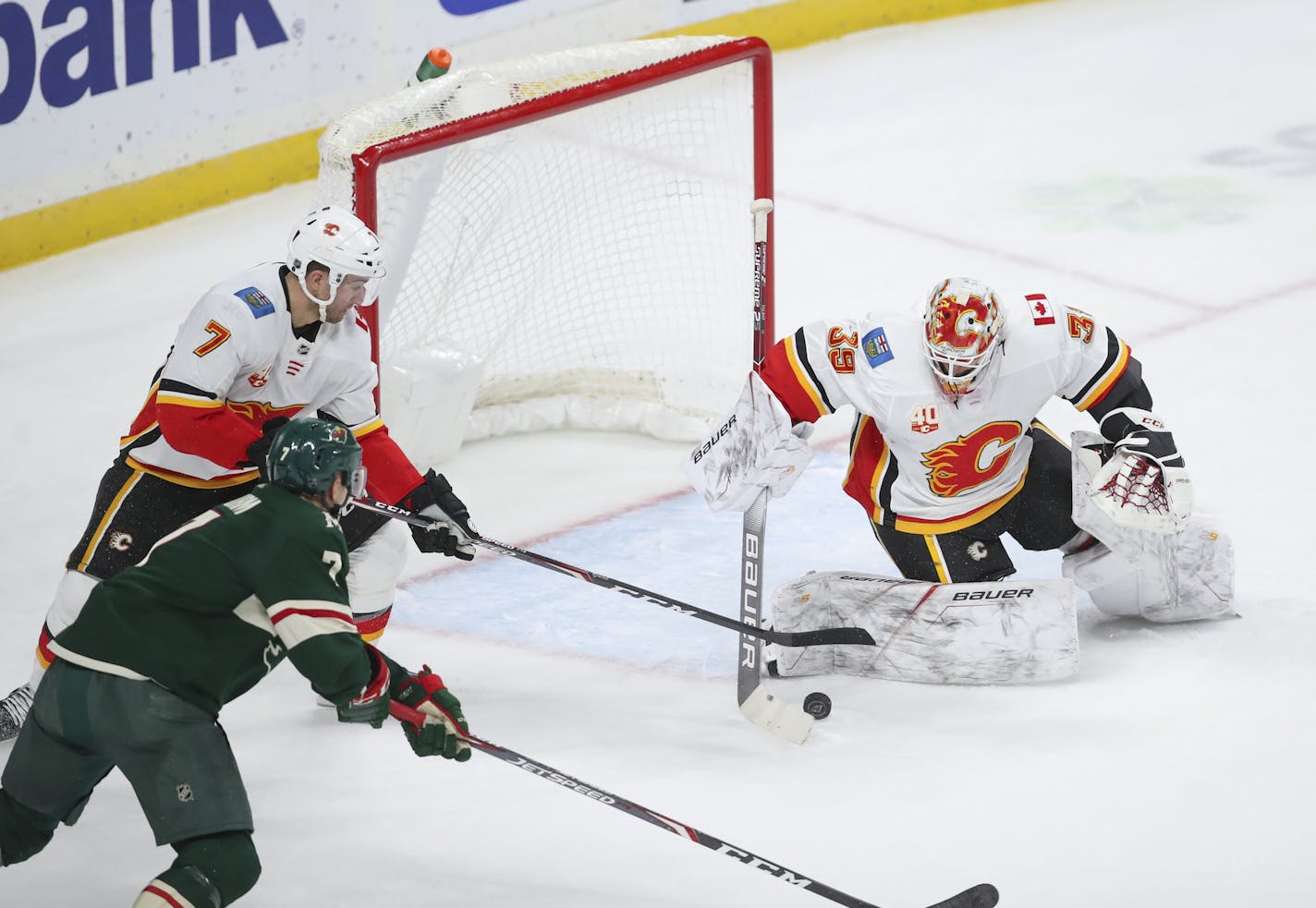 Calgary Flames goaltender Cam Talbot (39) and Flames defenseman TJ Brodie (7) moved to control the rebound from a second period shot before Minnesota Wild center Nico Sturm (7) could get to it. ] JEFF WHEELER • Jeff.Wheeler@startribune.com The Minnesota Wild faced the Calgary Flames in an NHL hockey game Monday evening, December 23, 2019 at Xcel Energy Center in St. Paul.