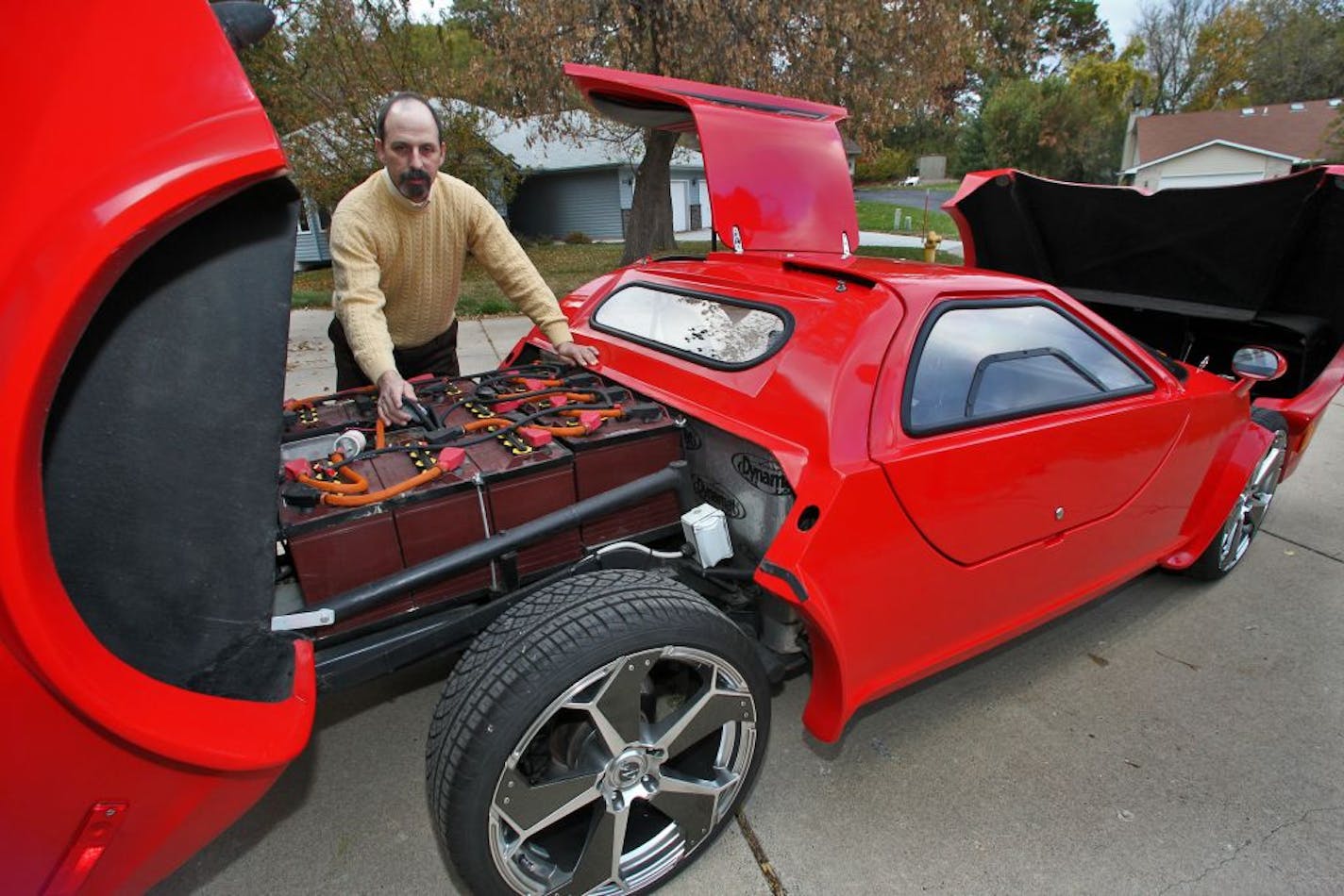 Roque Haines converted an internal combustion car to an all-electric car called the Electric Aztec 7 in his St. Paul garage. Haines displayed some of the cars 15 batteries that are series wired together to provide the car's power. (MARLIN LEVISON/STARTRIBUNE(mlevison@startribune.com