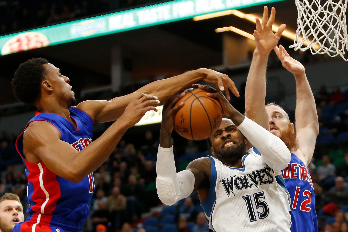 Minnesota Timberwolves forward Shabazz Muhammad (15) tries to grab a rebound against Detroit Pistons guard Ish Smith (14) and center Aron Baynes (12) in the first half