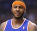 New York Knicks' Carmelo Anthony reacts to an official's call during the second half of an NBA basketball game against the Phoenix Suns, Friday, March