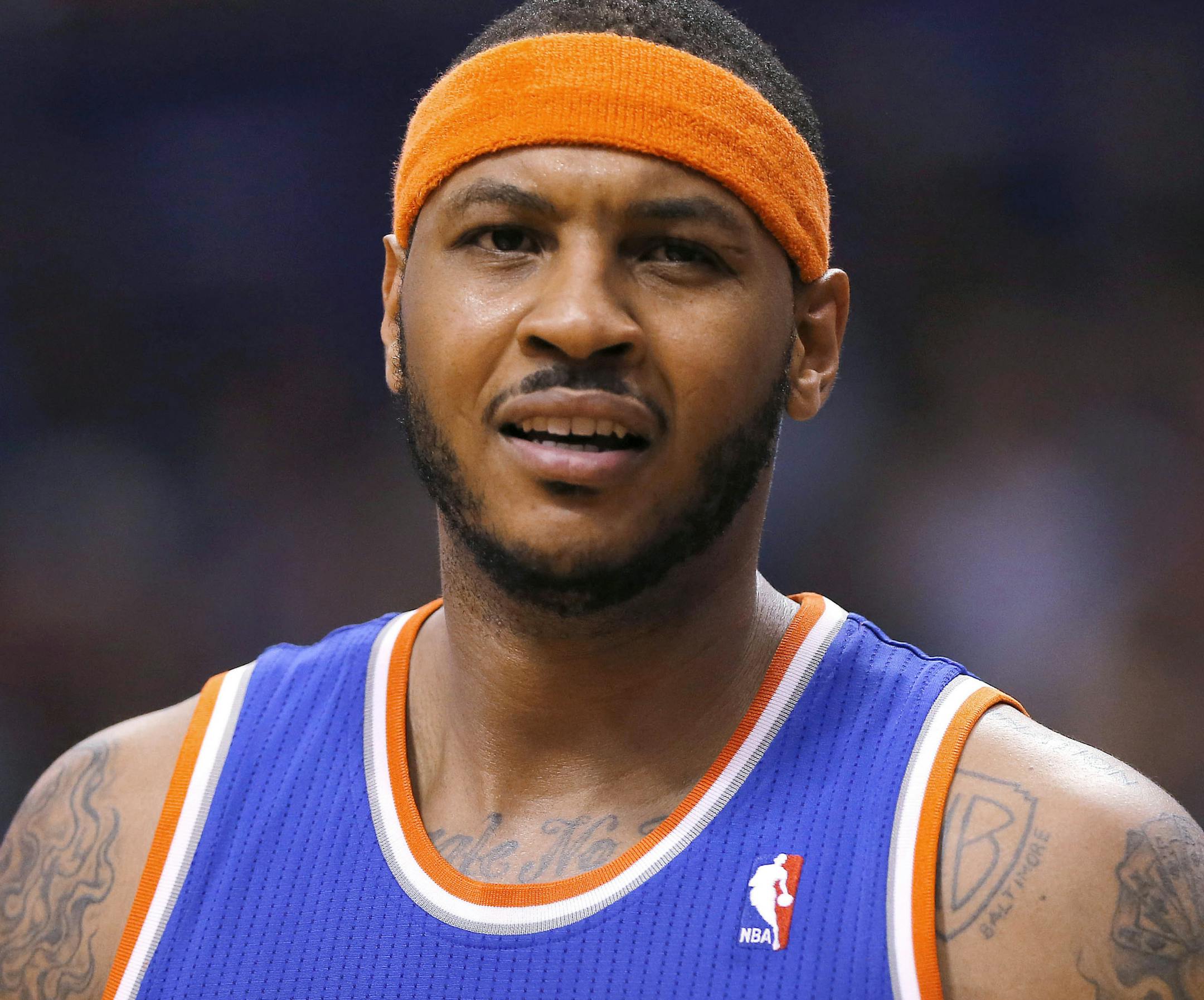 New York Knicks' Carmelo Anthony reacts to an official's call during the second half of an NBA basketball game against the Phoenix Suns, Friday, March 28, 2014, in Phoenix. The Suns won 112-88. (AP Photo/Matt York) ORG XMIT: AZMY114