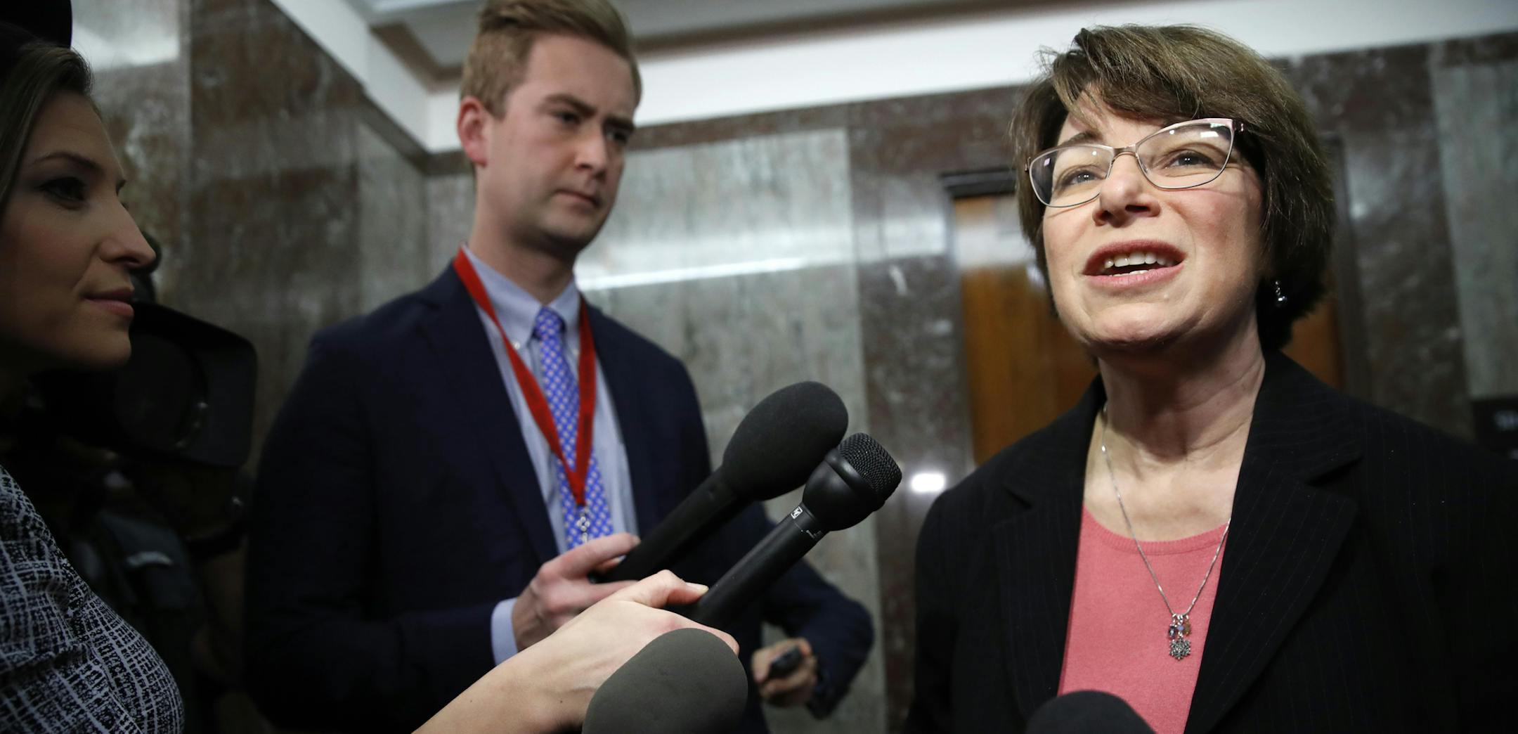 Sen. Amy Klobuchar, D-Minn., right, speaks to the media on Day Three of the government shutdown, after attending a meeting with a bipartisan group of senators, Monday Jan. 22, 2018, on Capitol Hill in Washington. (AP Photo/Jacquelyn Martin)