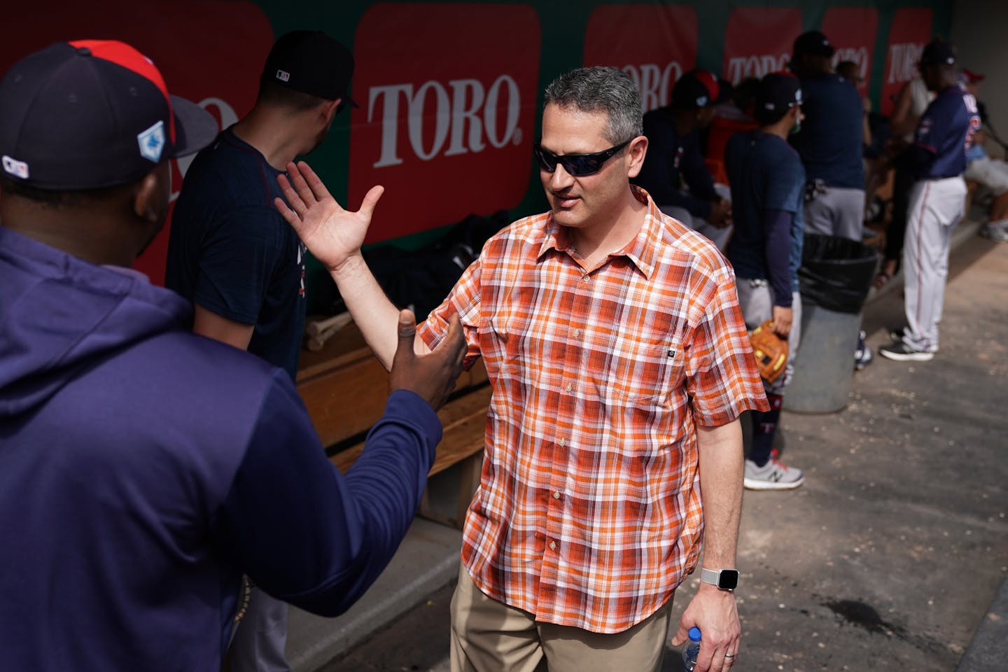 Thad Levine greeted third baseman Miguel Sano during last year's spring training.