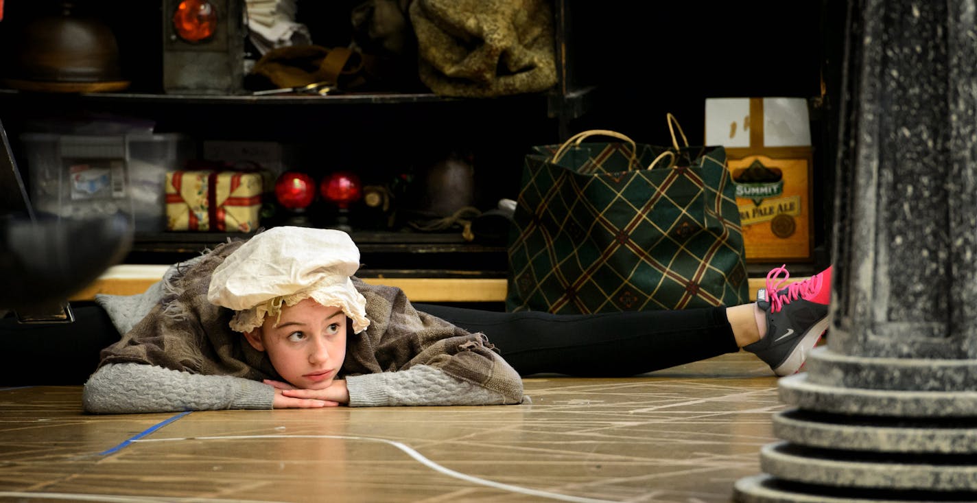 Delaney Hunter, 12, who plays Martha Cratchit, stretched before rehearsal of the Guthrie&#x2019;s &#x201c;A Christmas Carol.&#x201d;