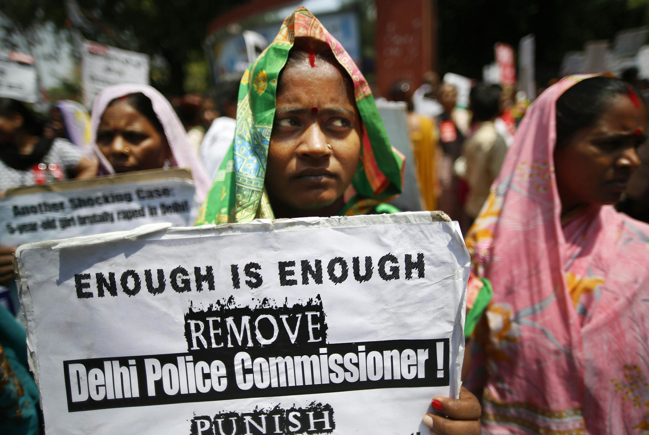 An Indian woman holds a poster as she protests with others against how Indian authorities handle sex crimes near the Parliament in New Delhi, India, Monday, April 22, 2013 after a second suspect was arrested in the rape of a 5-year-old girl. Child rights activists say the rape last week of the girl is just the latest case in which Indian police failed to take urgent action on a report of a missing child. Three days after the attack, the girl was found alone in locked room in the same New Delhi b