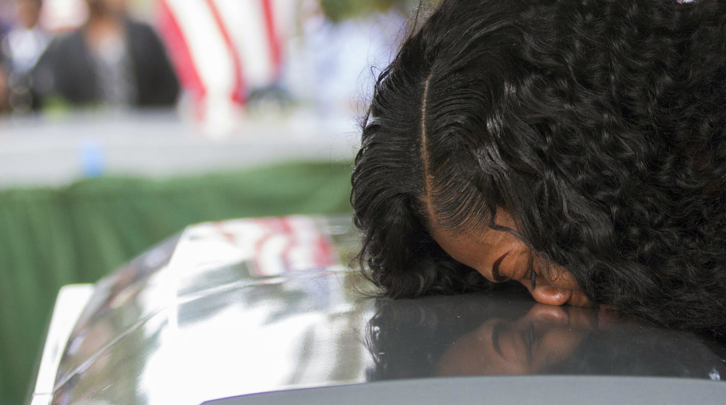 FILE - In this Saturday, Oct. 21, 2017, file photo, Myeshia Johnson kisses the casket of her husband, Sgt. La David Johnson during his burial service at Fred Hunter's Hollywood Memorial Gardens in Hollywood, Fla. Myeshia Johnson told ABC's "Good Morning America" on Monday, Oct. 23, 2017, that she has nothing to say to the president, adding that his phone call to her made "me cry even worse." (Matias J. Ocner/Miami Herald via AP, File)