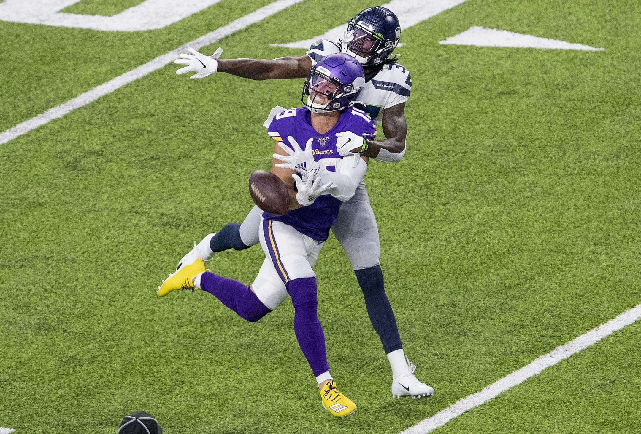 Seattle Seahawks' Tre Flowers (37) was called for pass interference while covering Minnesota Vikings' Adam Thielen (19) in the first quarter.