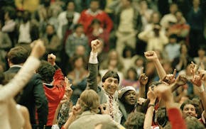 FILE - In this April 4, 1983, file photo, North Carolina State coach Jim Valvano, center with fist raised, celebrates after his basketball team defeat