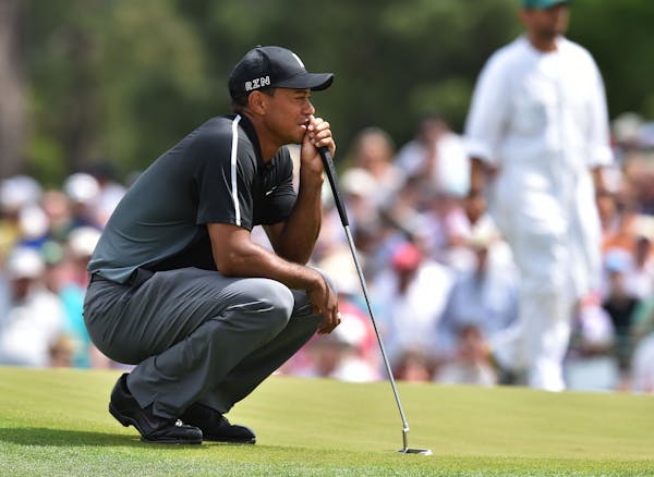 Tiger Woods lines up a birdie attempt on the 7th green during the second round of the Masters at Augusta National Golf Club on Friday, April 10, 2015,