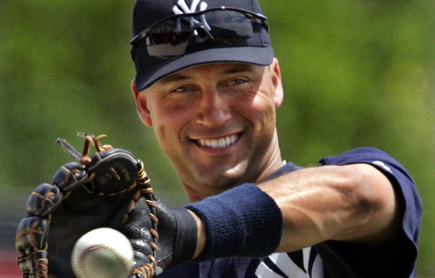 New York Yankees shortstop Derek Jeter warms up before spring training action against the Cincinnati Reds Wednesday, March 30, 2005 in Sarasota, Fla..(AP Photo/Gene J. Puskar) ORG XMIT: FLGP108