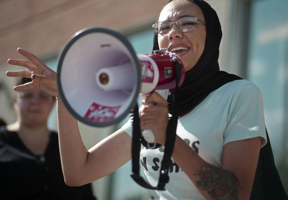 Vanessa Taylor of Black Liberation Project voiced her opposition to police presence in Minneapolis schools to supporters .