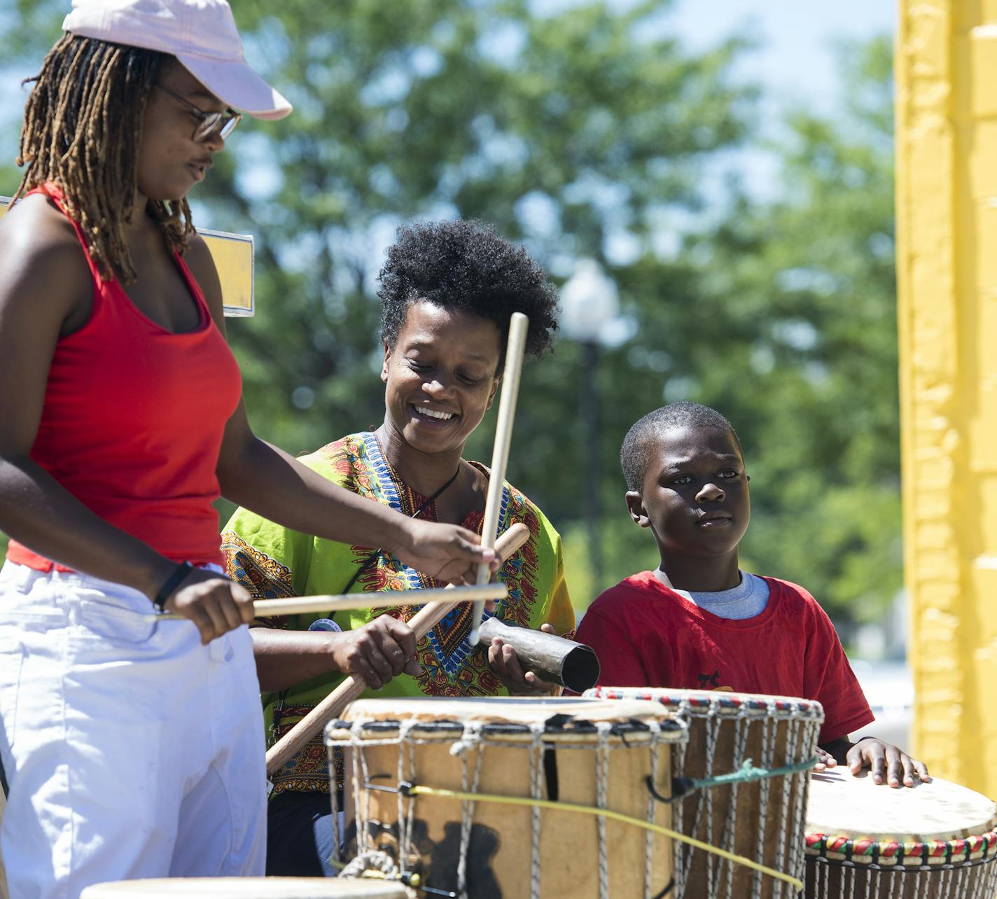 From left, Yonci Jameson, Kenna Cottman and Ebrima Sarge, 9, played drums as part of the Freedom Square dedication along West Broadway Avenue on Friday. The trio is part of the Voice of Culture, a drum and dance cultural group. ] Isaac Hale &#x2022; isaac.hale@startribune.com Freedom Square was dedicated at the intersection of West Broadway Avenue and Logan Avenue North in Minneapolis, MN, on Friday, July 29, 2016. In addition to the new public plaza, benches and bike racks were also implemented